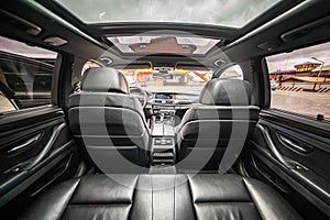 Car inside. Interior of prestige modern car. Comfortable leather seats. Black cockpit with on isolated white background