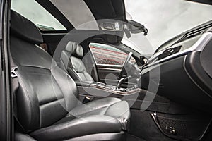 Car inside. Interior of prestige modern car. Comfortable leather seats. Black cockpit with on isolated white background