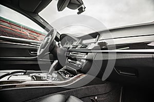 Car inside. Interior of prestige modern car. Comfortable leather seats. Black cockpit with on isolated white background