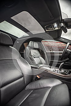 Car inside. Interior of prestige modern car. Comfortable leather seats. Black cockpit with on  white background