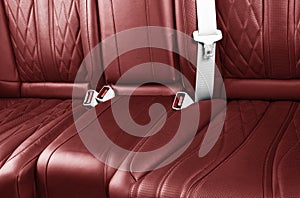 Car inside. Interior of prestige modern car. Comfortable leather seats. Red perforated leather. Back passenger seats