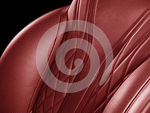 Car inside. Interior of prestige modern car. Comfortable red leather seats. Perforarated leather with isolated black background