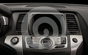 Car inside. Multimedia screen and control panel close-up. Interior details.