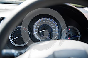 Car instrument panel dashboard automobile control illuminated panel speed display, close up and shallow depth of field