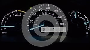 Car instrument panel (22222 miles). Illuminated in the night.