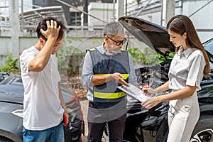 Car insurance agent showing his female client where to sign the accident insurance claim form while the guilty man standing near