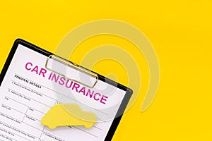 Car insurance concept with form, car toy on yellow background top view mockup