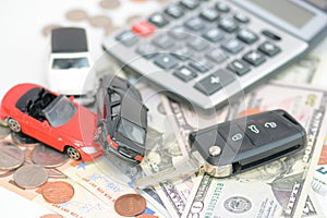 Car insurance concept with toy cars, car key, coins and bills