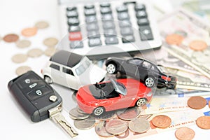 Car insurance concept with toy cars, car key, coins and bills