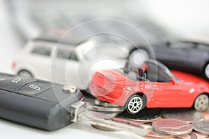 Car insurance concept with toy cars, car key, coins and bills