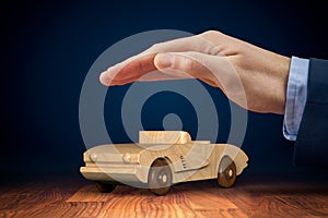 Car insurance concept with wooden toy