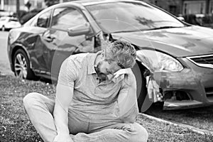 Car insurance. Sad depressed man assistance with car broken on road.