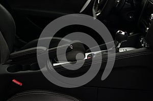 Car interior detail. Shift lever in modern sport car. Viev from passenger seat.