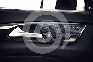 Car interior details. Door handle and electronic memory for the chairs.