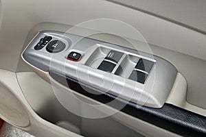 Car interior details of door handle with windows controls and ad