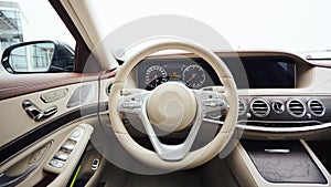 Car interior luxury. Interior of prestige modern car. Leather comfortable seats, dashboard and steering wheel. White