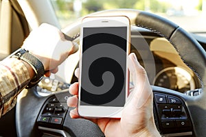 Car interior with male driver sitting behind the wheel, soft sunset light. Luxurious vehicle dashboard and electronics.