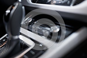 Car interior. Modern car illuminated dashboard. Luxurious car instrument cluster. Close up shot of automobile instrument panel