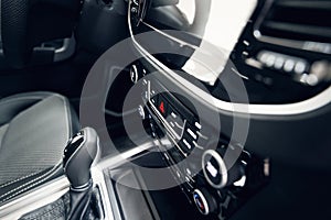 Car interior. Modern car illuminated dashboard. Luxurious car instrument cluster. Close up shot of automobile instrument panel