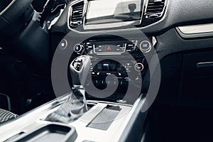 Car interior. Modern car illuminated dashboard. Luxurious car instrument cluster. Close up shot of automobile instrument panel