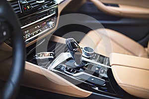 Car Interior: Modern Center Console with dials, buttons and gear knob photo