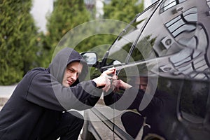 Car jacking thief steal car breaking door criminal job burglar Hijacks  Auto thief black balaclava hoodie trying  break into