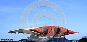 Car with kayak canoe on top blue sky. Active lifestyle