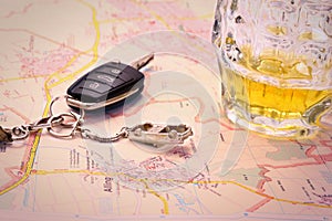 Car key with accident and beer mug on map