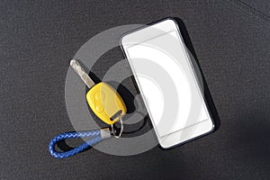 Car key. Auto remote control, flip key on a mobile phone, black background. Vehicle engine start, doors and trunk open and close