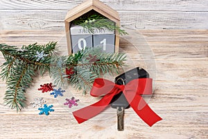 Car key with colorful bow and calendar, christmas tree, branches, snowflakes, on wooden background