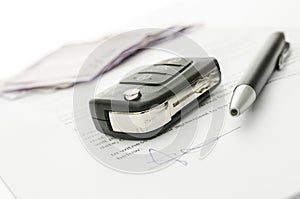 Car key on a contract of car sale