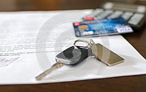 Car key, credit card on a signed sales contract