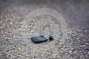 Car key fall on the asphalt road. Driver lost his vehicle keys