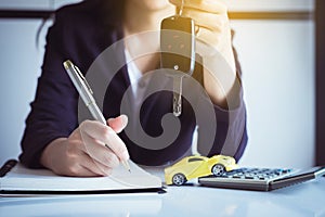 Car key on hand with auto dealership and rental ,Car finance concept