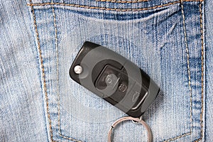 Car key on jeans denim background, car sale and rental concept