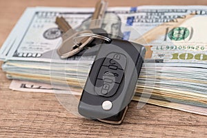 Car key lying on US 100 dollar bills