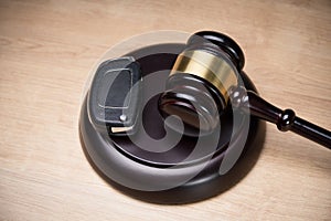 Car Key And Mallet On The Striking Block Over Table