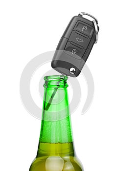 Car key in neck of bottle of bee - studio shot over white