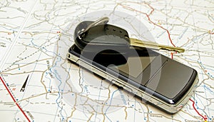 Car key and phone on map