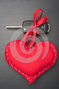Car key with red bow and a heart