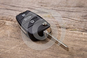 Car key with remote alarm control on the wooden desk