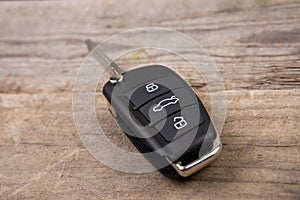 Car key with remote alarm control on the wooden desk