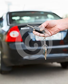 Car key with remote control in hand