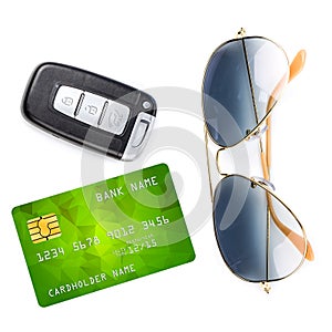 Car key with remote control, sunglasses and credit card, isolated