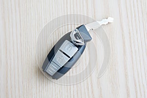 Car key with remote control on the wooden floor