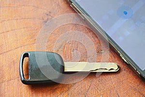 car key and smart phone opened map on table