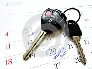 Car key on white calendar and made circle marked on date numbers.