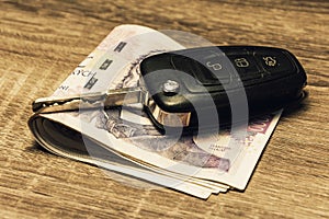 Car keys and banknotes as the concept of buying or renting a car