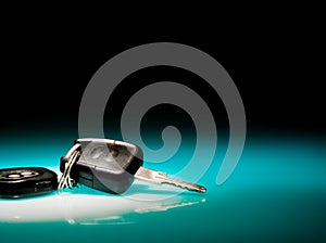 Car keys on blue, reflective table