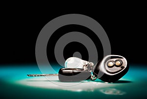 Car keys on blue, reflective table